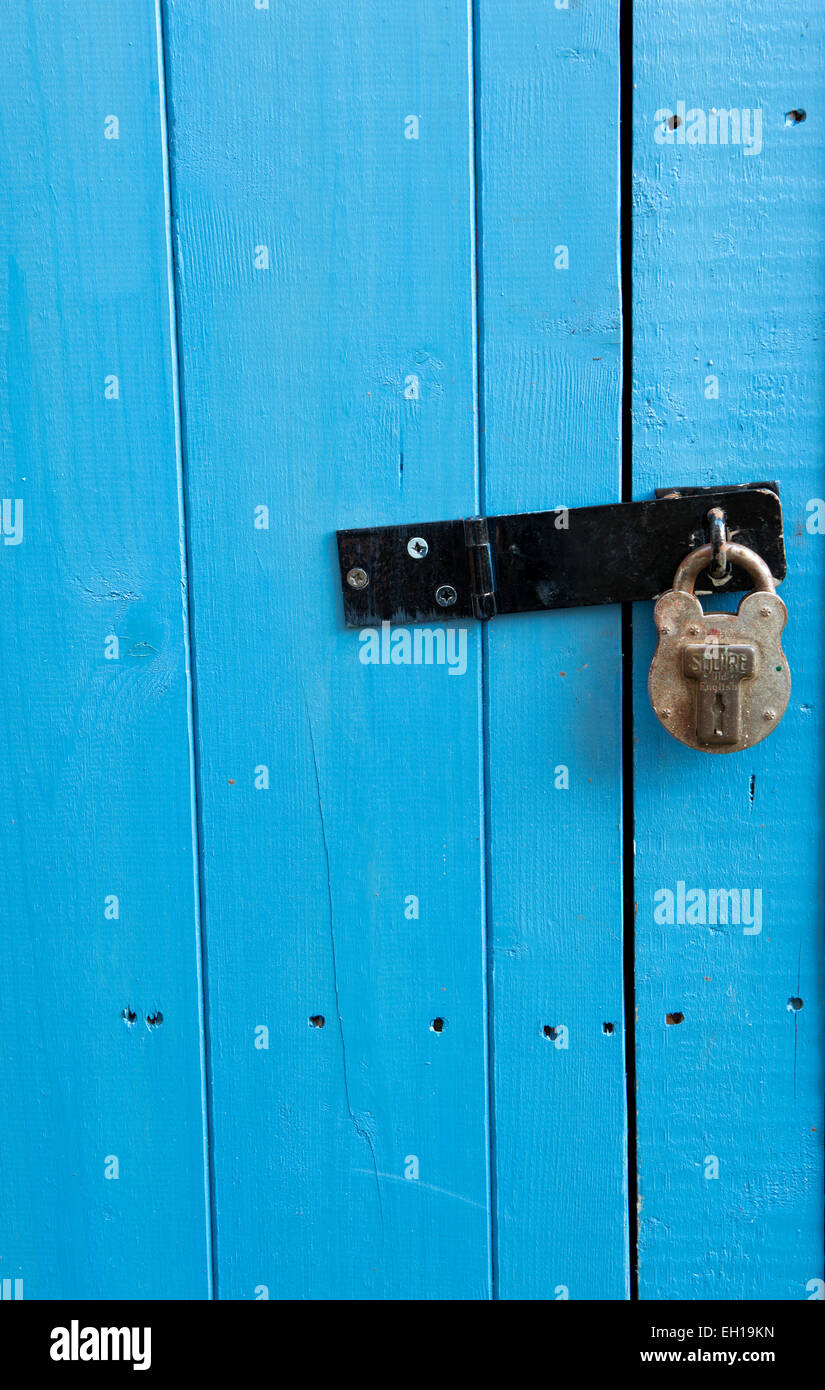 Padlocked painted blue shed door. UK Stock Photo