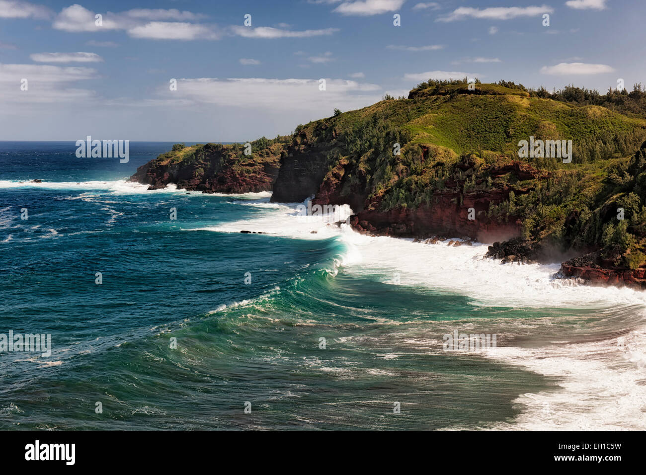 The relentless Pacific Ocean crashes against the cliffs overlooking Honolua Bay on Hawaii's island of Maui. Stock Photo