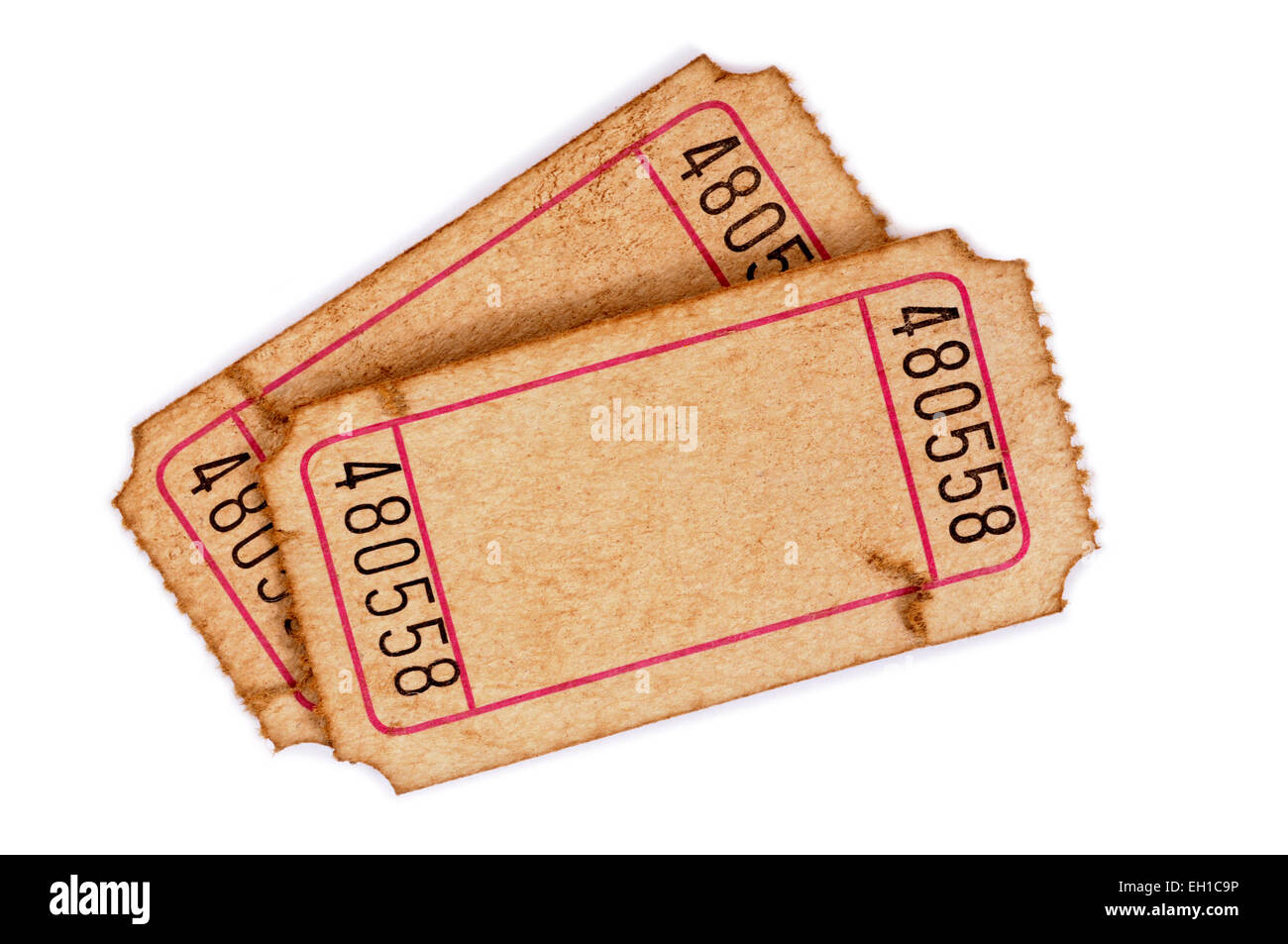 Pair of old stained and torn blank admission tickets on a white background. Stock Photo