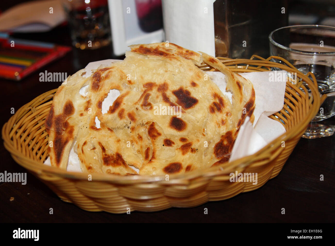 Freshly made roti canai served in a plastic basket Stock Photo