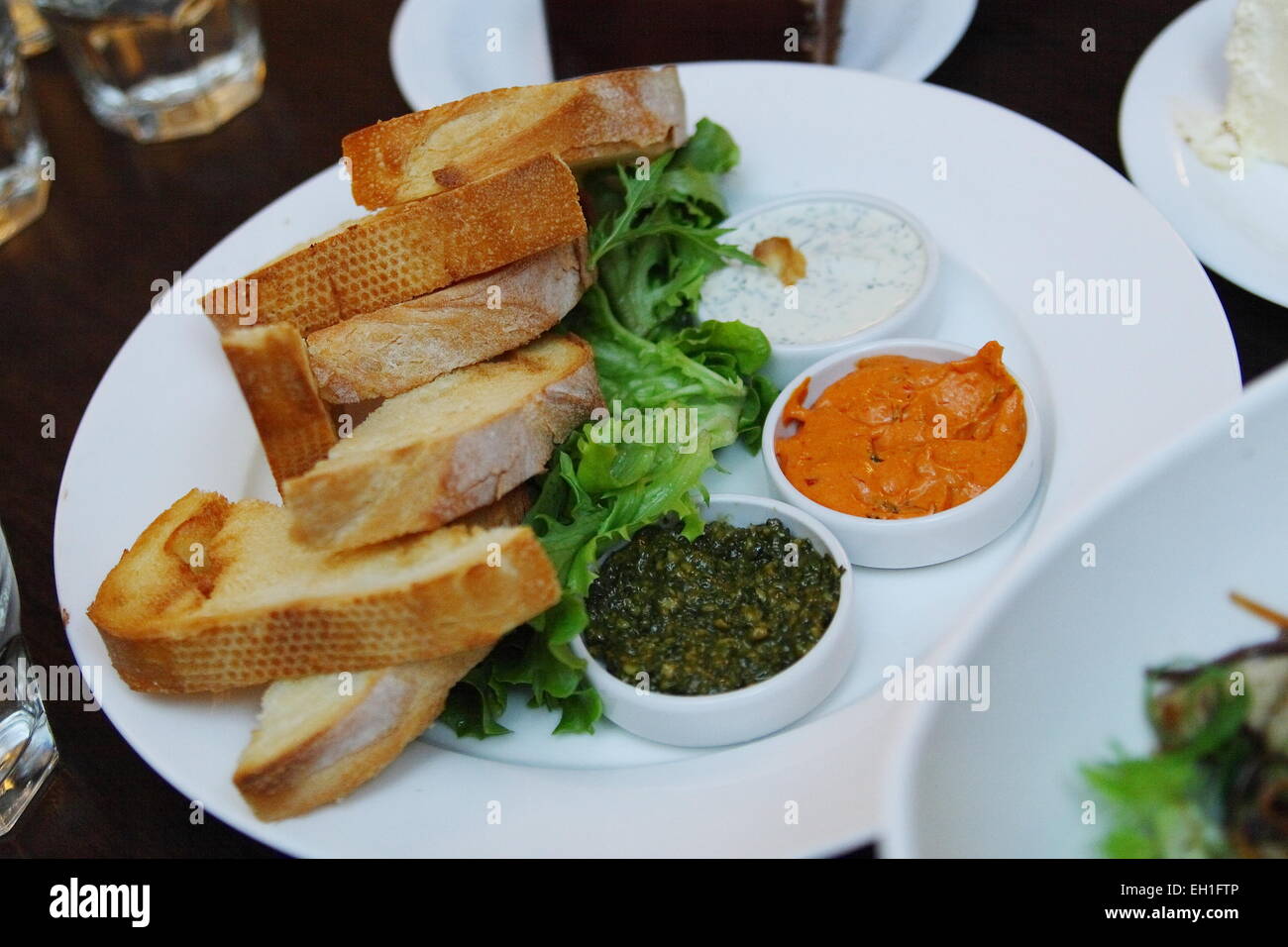 Crusty breads with dips and salad Stock Photo Alamy