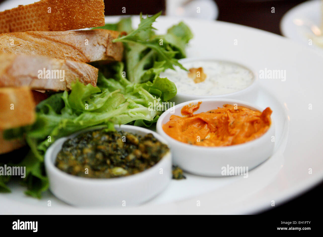 Crusty breads with dips and salad Stock Photo Alamy