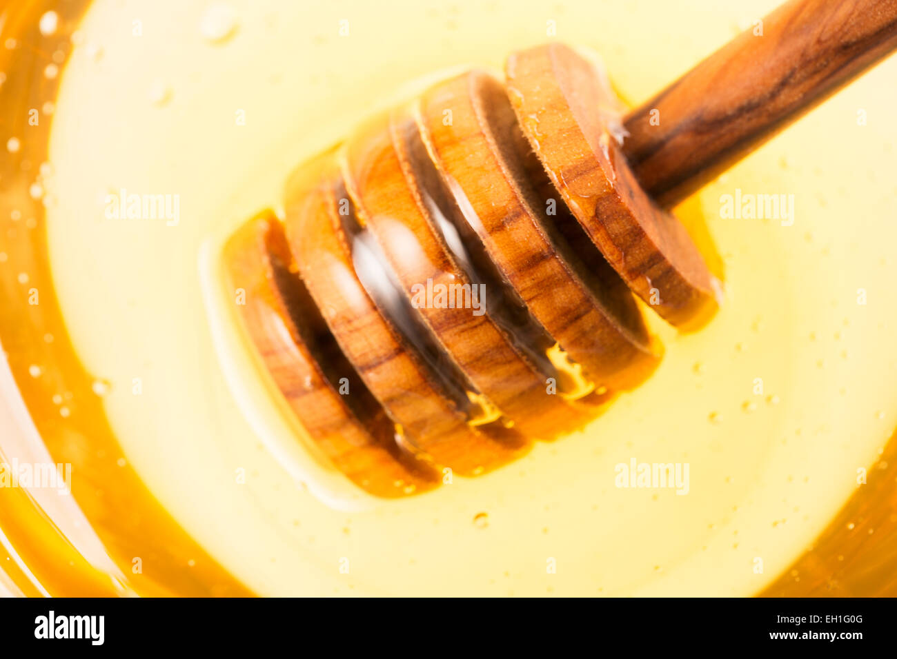 Close up of honey dipper in honey jar. Stock Photo