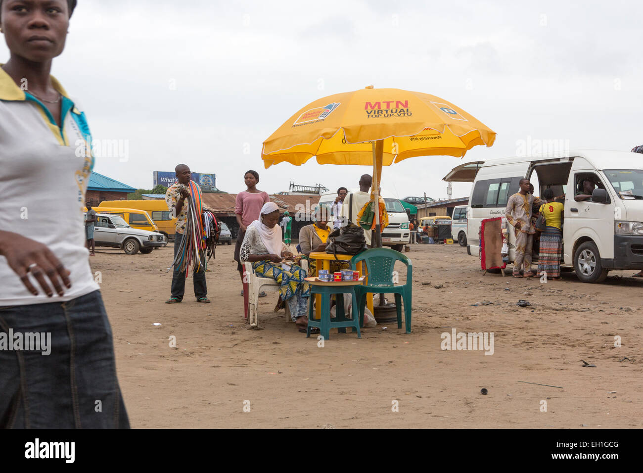 Lagos, Nigeria; People sit under an MTN umbrella in a carpark in th