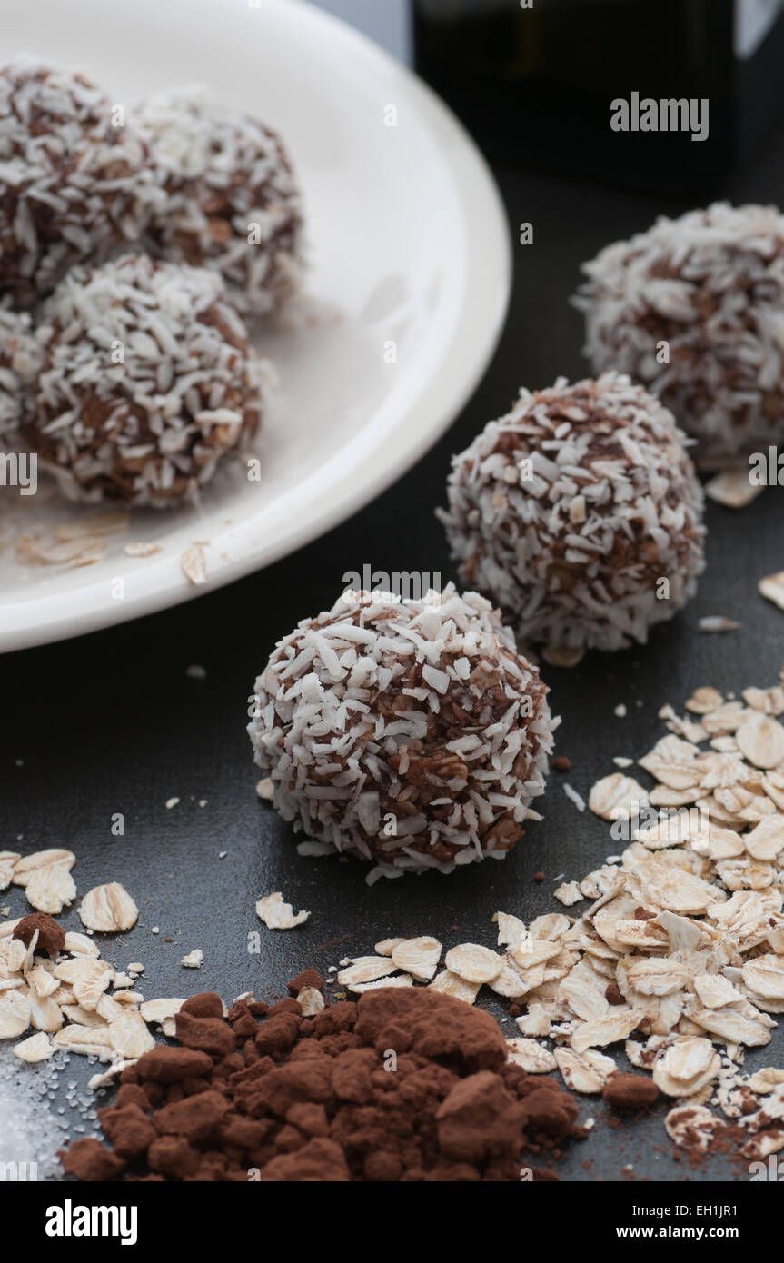 Chocolate candy balls rolled in grated coconut. Stock Photo