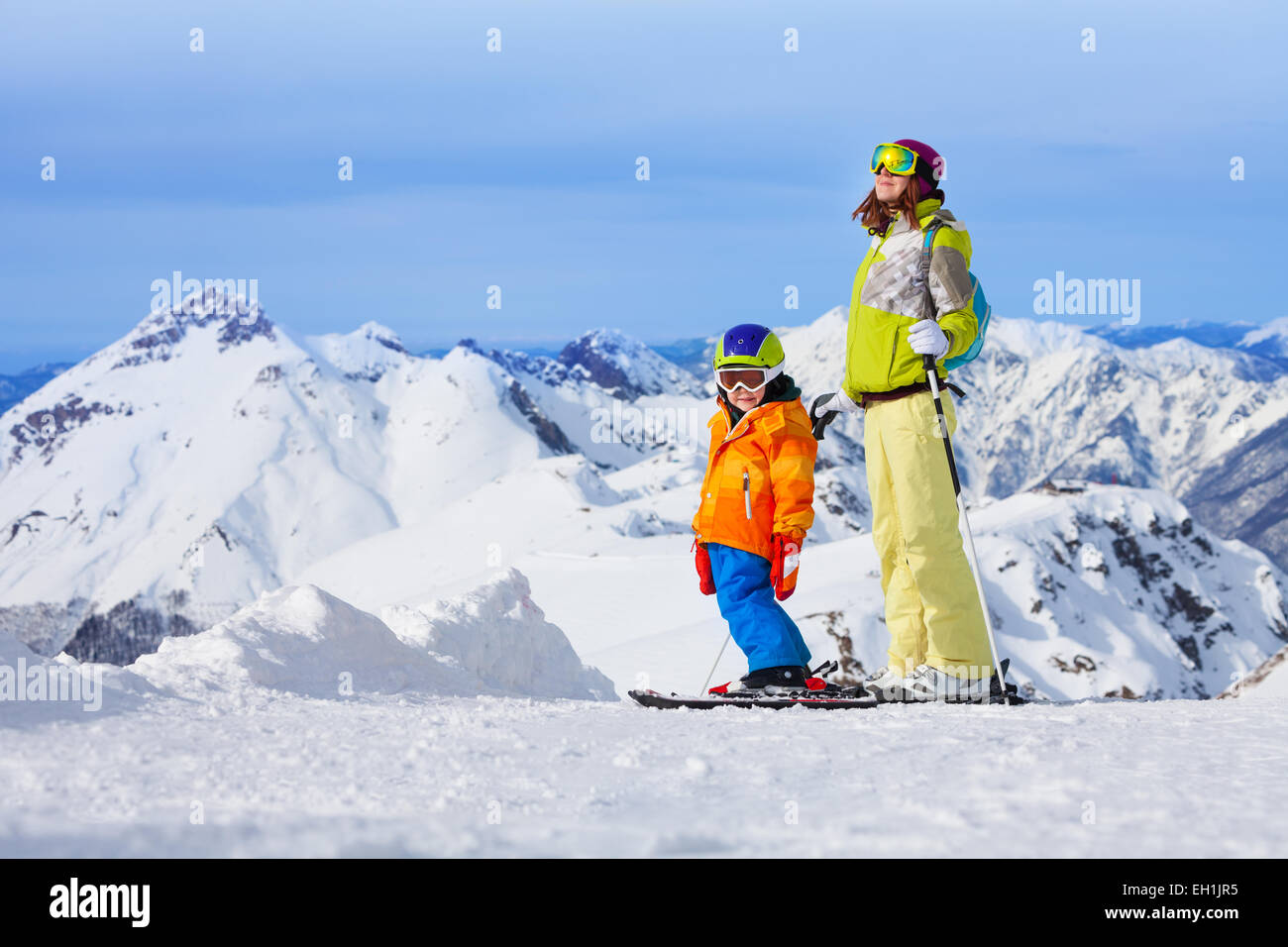 Ski vacation in mountains, woman and child happy Stock Photo