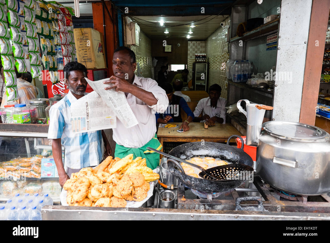 Chai wallah, tea maker at his stall making puri and chai Stock Photo