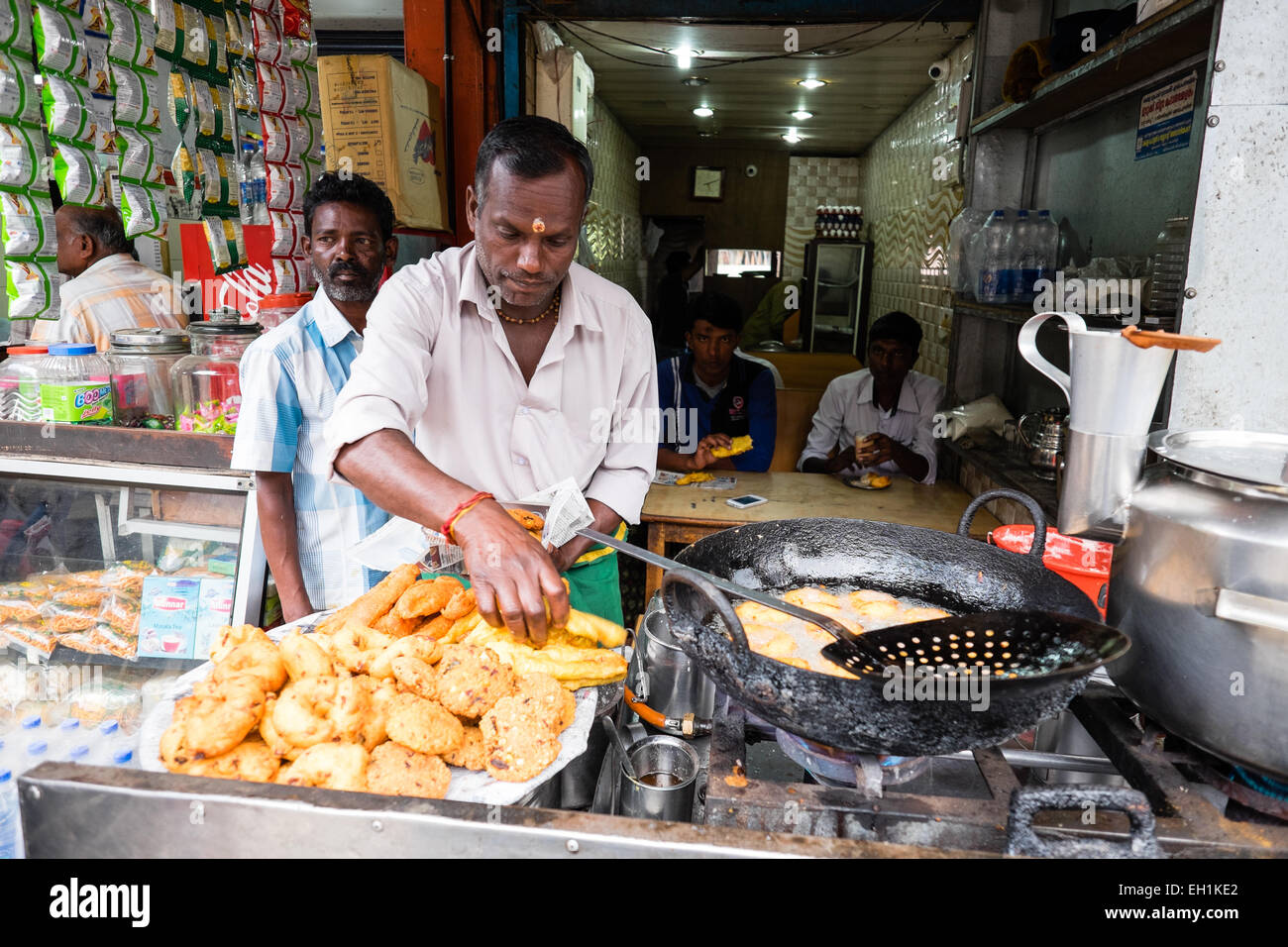 Chai wallah, tea maker at his stall making puri and chai Stock Photo