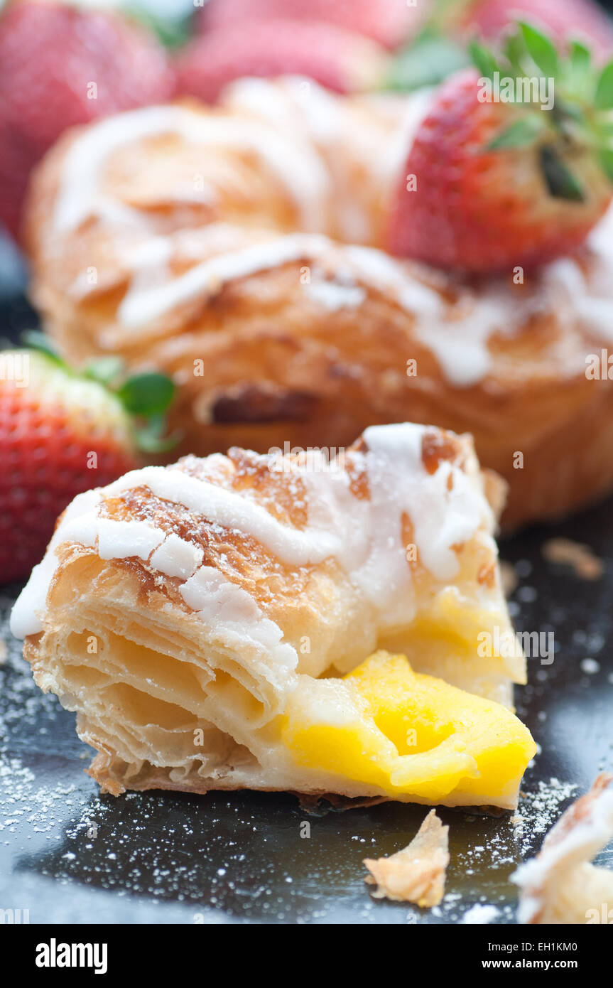 Vanilla cream filled danish pastry with frosting. Stock Photo