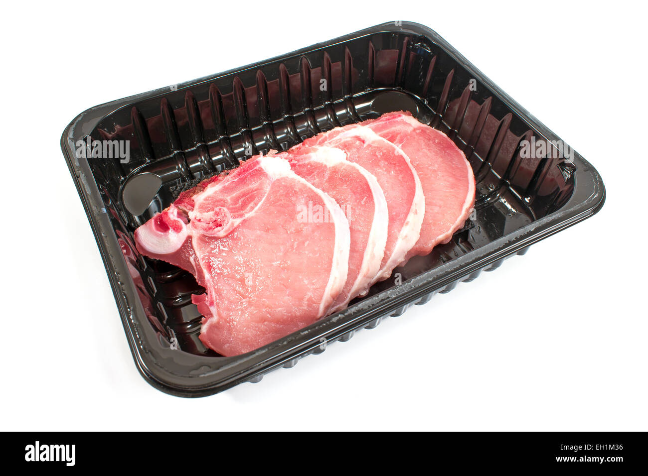 Pork chop meat in plastic bowl isolated on white Stock Photo