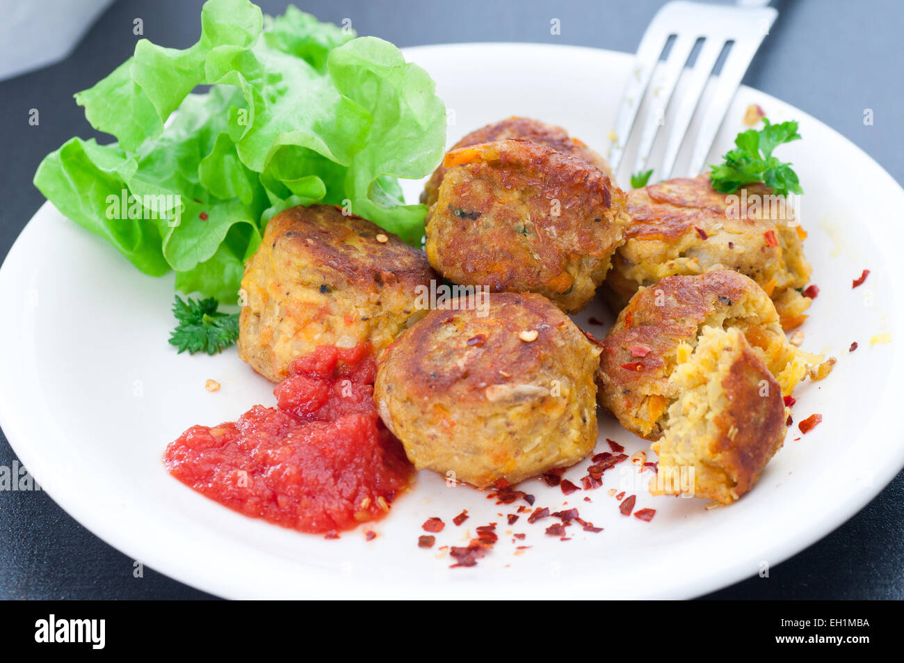 Turmeric and chili spiced veggie balls served with tomato and chili sauce. Stock Photo