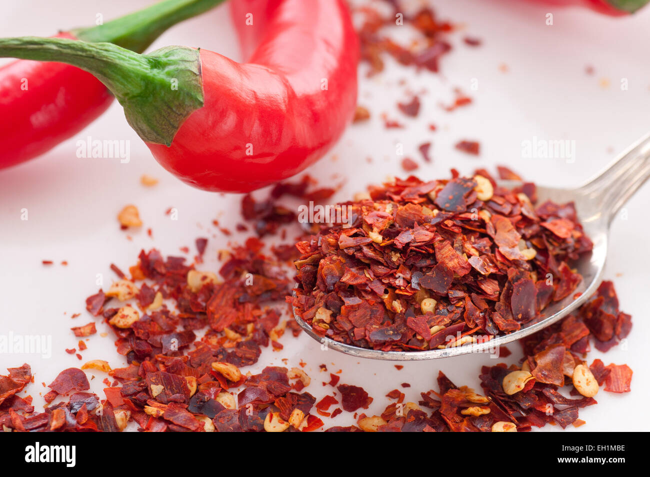 Spoon with red chili pepper flakes. Stock Photo
