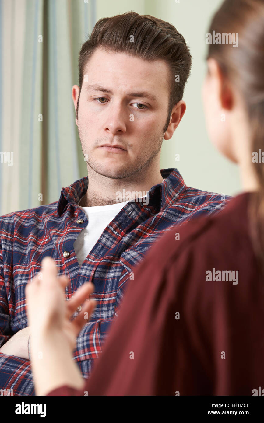 Depressed Young Man Talking To Counselor Stock Photo Alamy