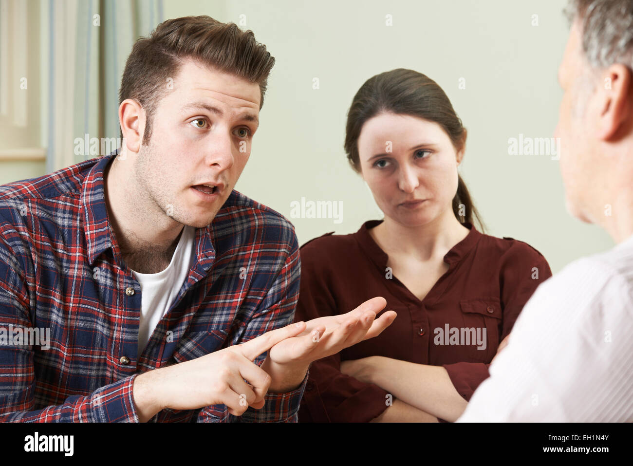 Couple Discussing Problems With Relationship Counsellor Stock Photo