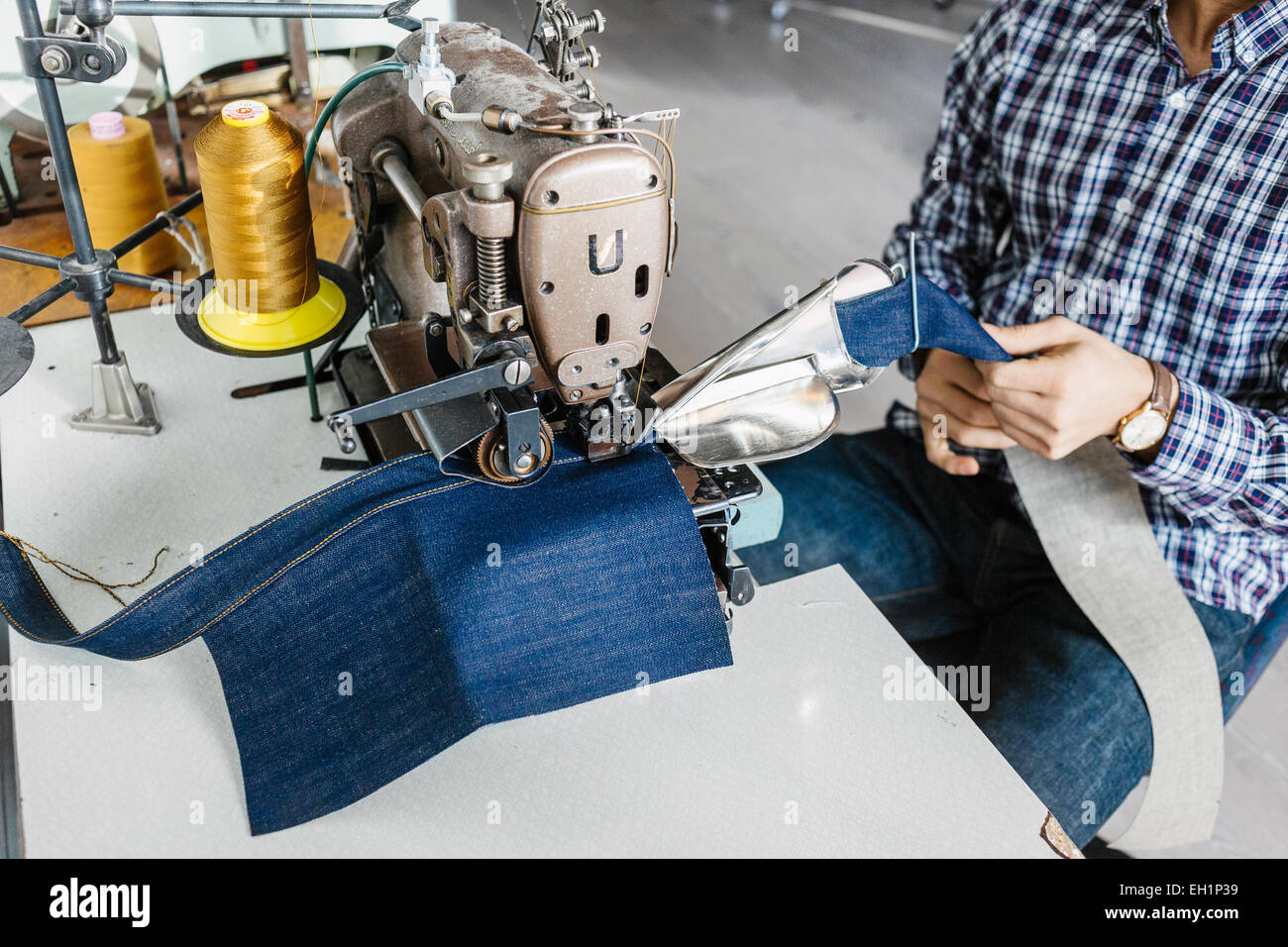 Midsection of tailor sewing jeans in factory Stock Photo Alamy