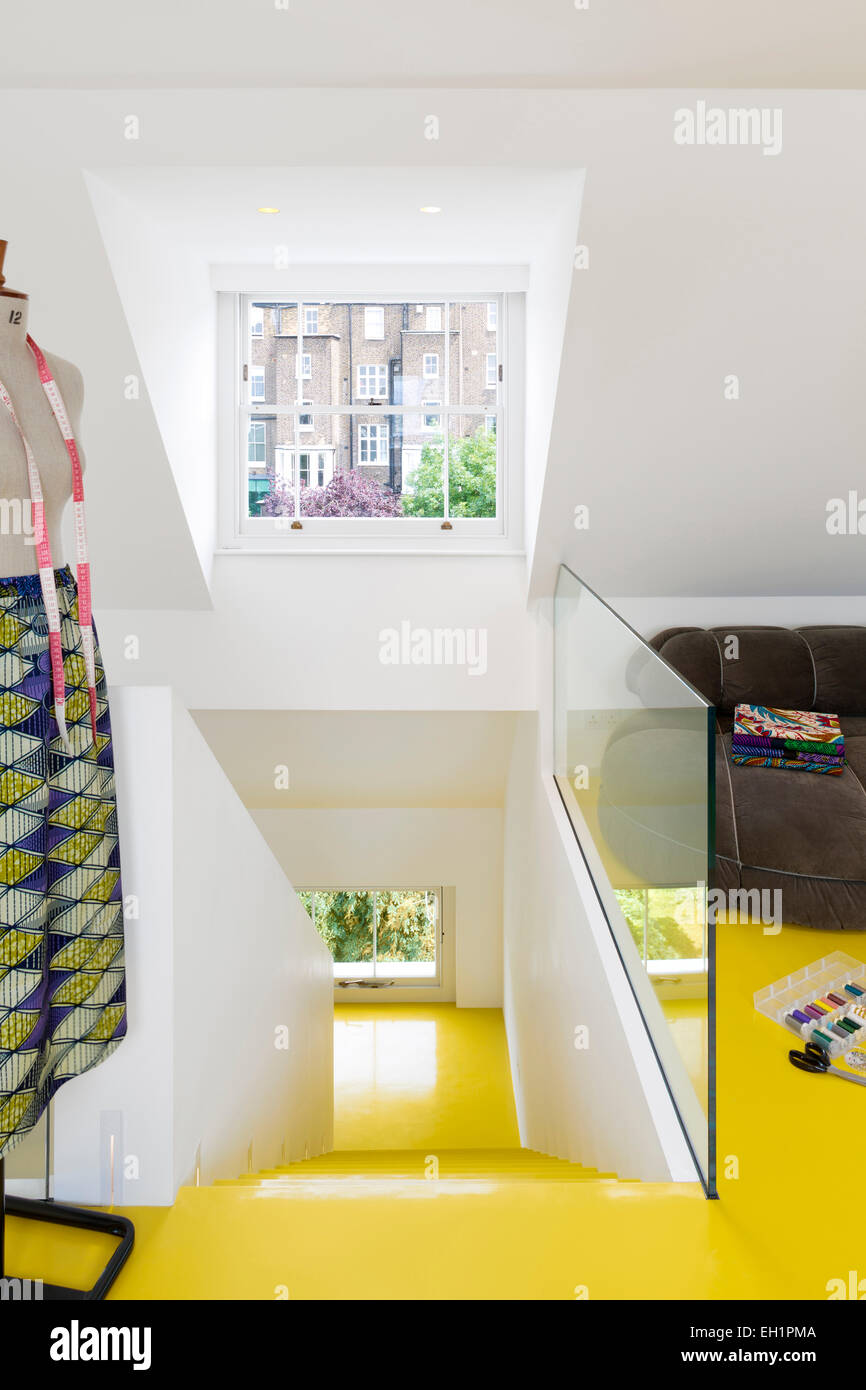 Yellow laminate flooring and staircase in open plan UK home Stock Photo Alamy