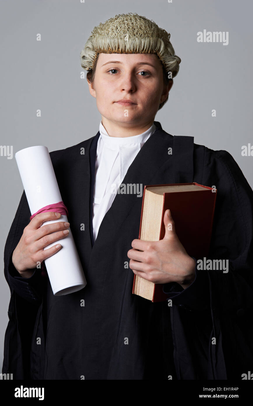 Studio Portrait Of Female Lawyer Holding Brief And Book Stock Photo