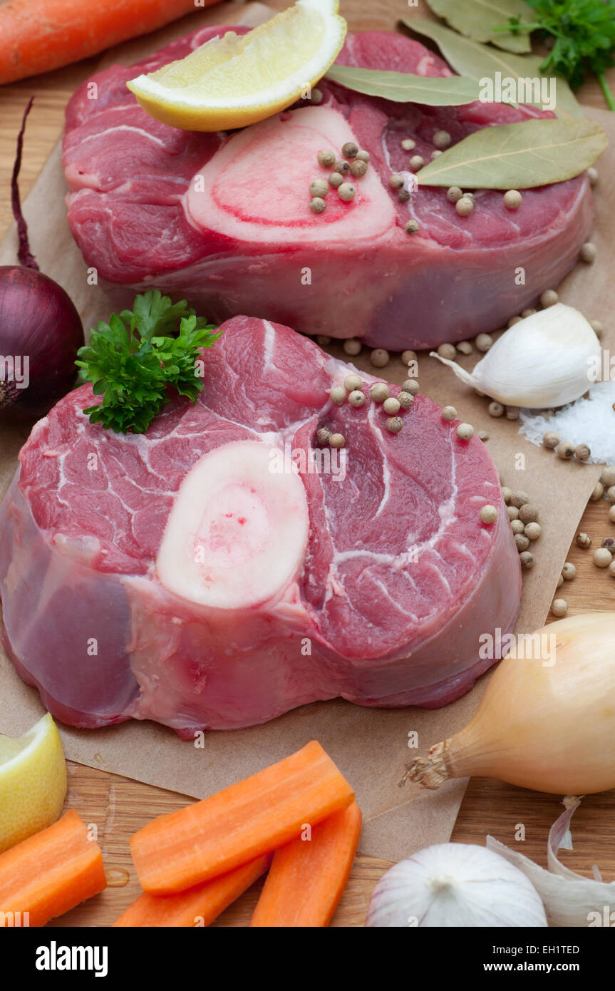 Raw veal shanks, carrot, onion, fresh parsley and spices. Stock Photo