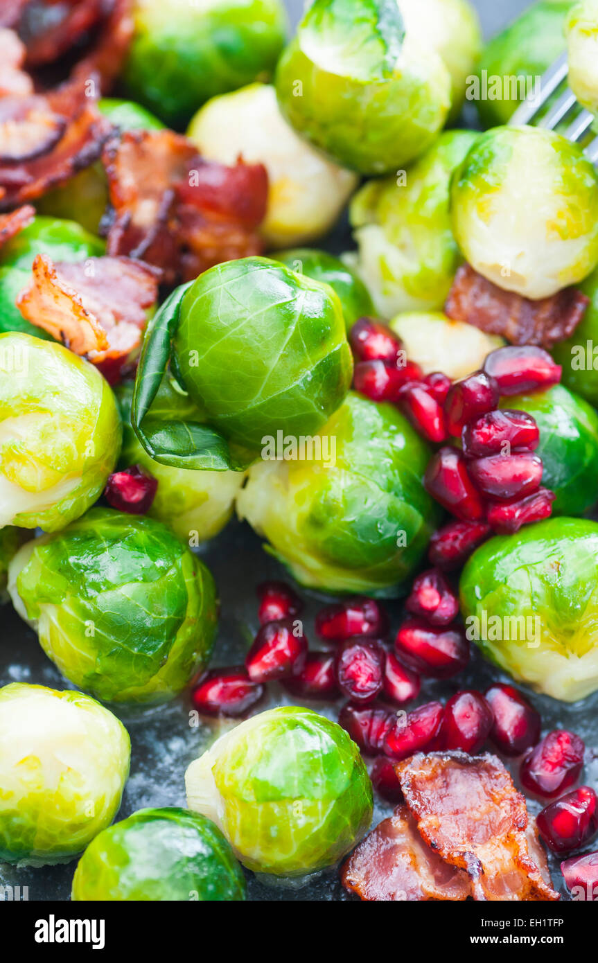 Buttered brussels sprouts with bacon and pomegranate. Stock Photo