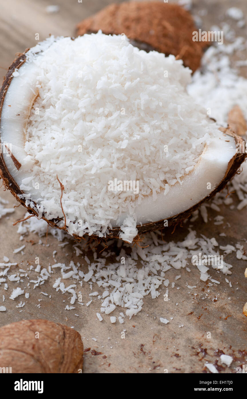 Grated coconut in a coconut shell. Stock Photo