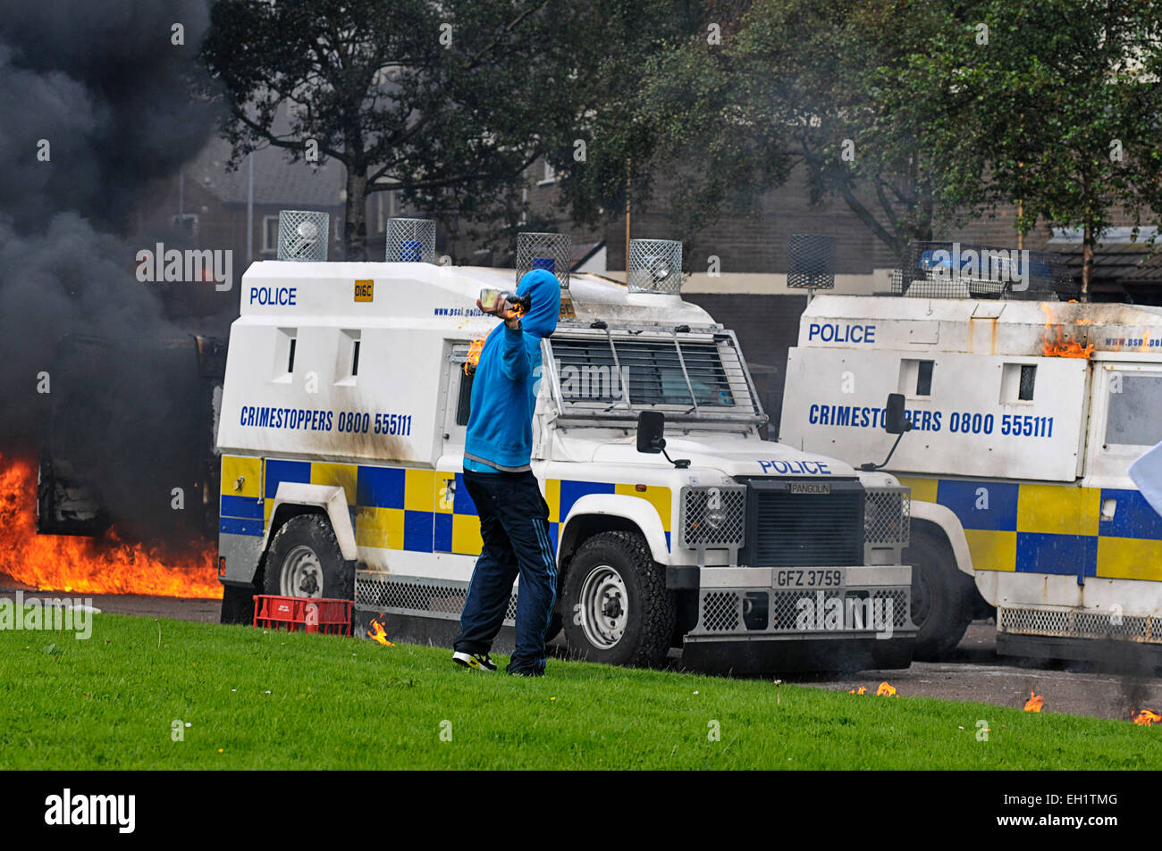 Nationalist youth throwing petrol bombs at PSNI vehicles during riots in the Bogside, Derry, Londonderry, Northern Ireland Stock Photo