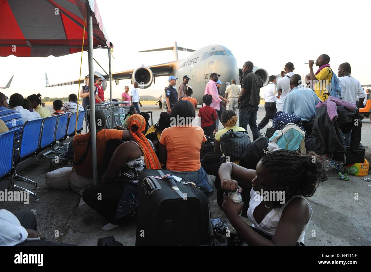 Haitian earthquake survivors evacuate on US military flights from Toussaint Louverture  Airport, Port Au Prince, Haiti. Stock Photo