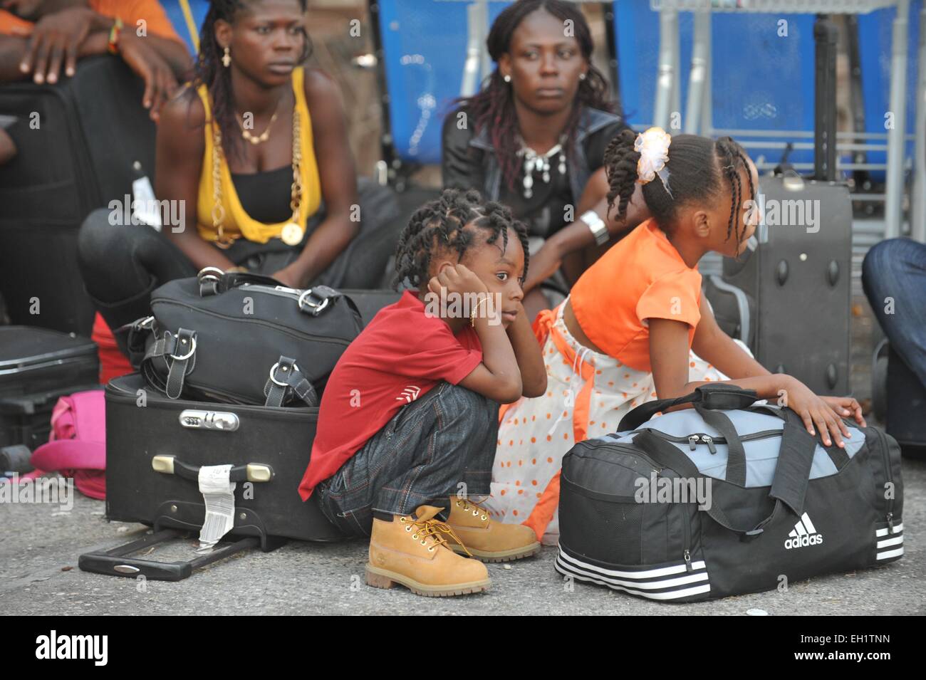 Haitian earthquake survivors evacuate on US military flights from Toussaint Louverture Airport, Port Au Prince, Haiti. Stock Photo