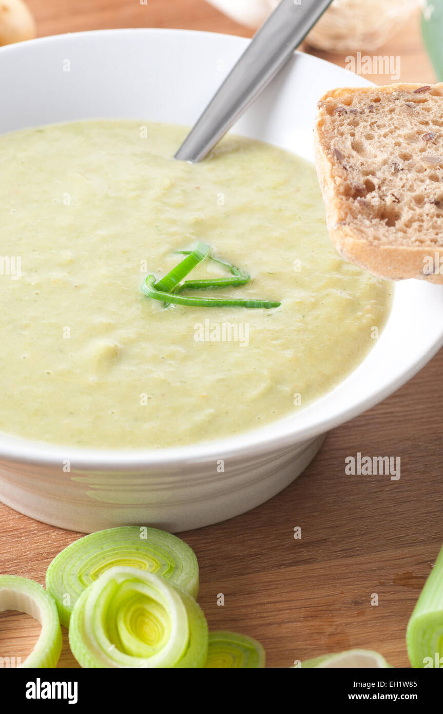 Leek and potato soup, served with a piece of bread. Stock Photo