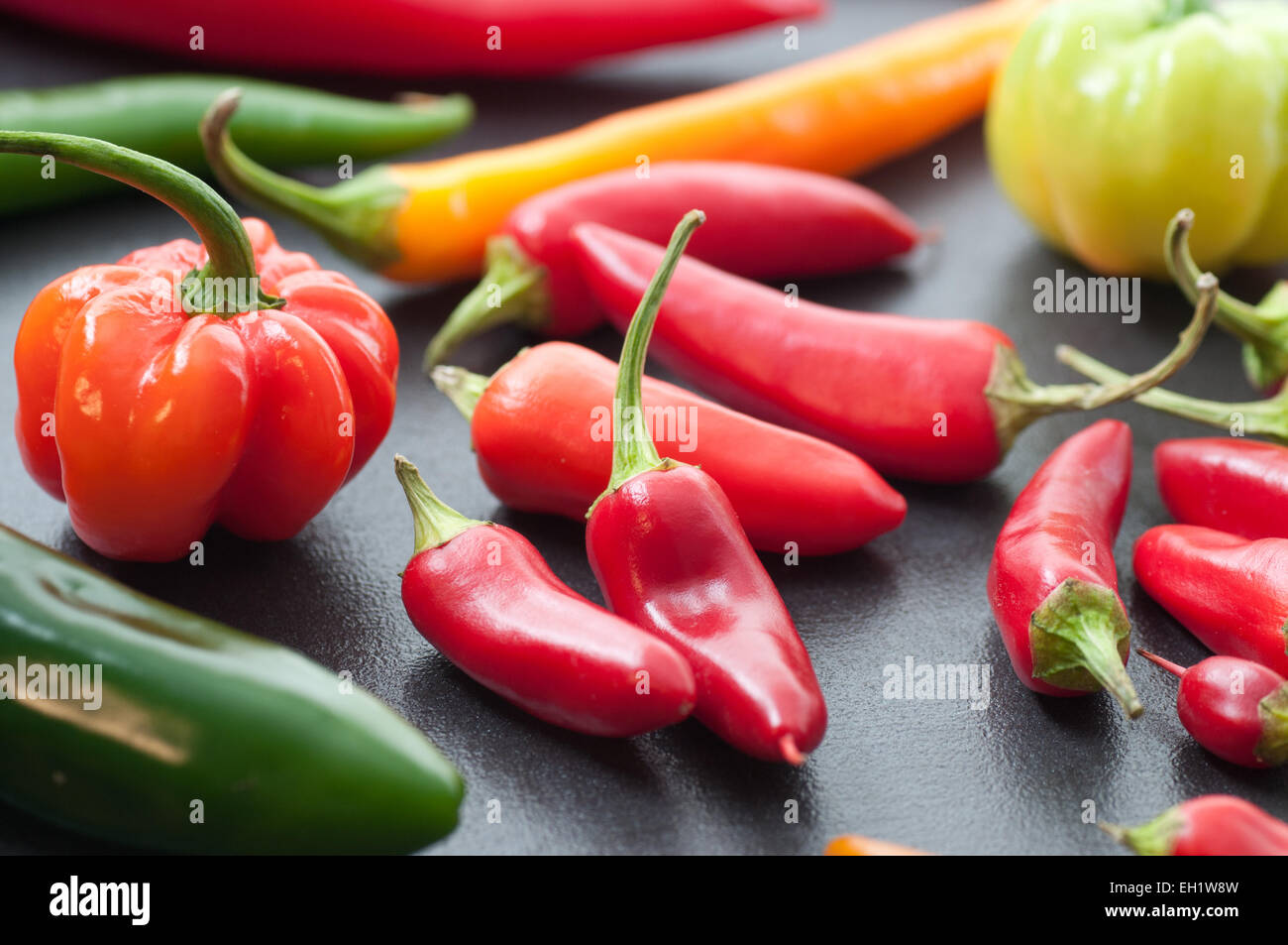 Various fresh hot chili peppers. Stock Photo