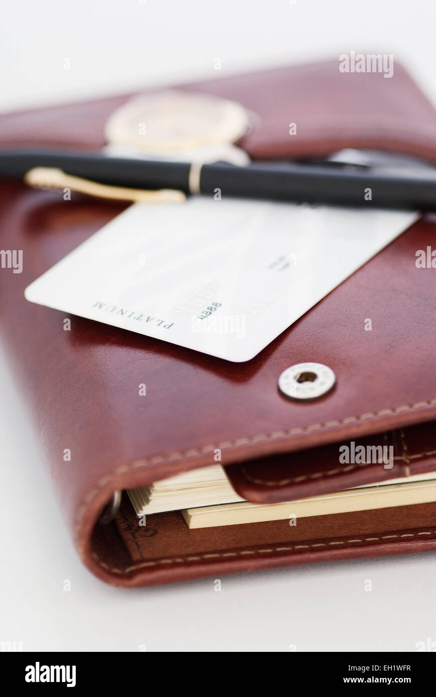 Agend Using Card A credit card,a pen and a watch on an agenda Stock Photo - Alamy