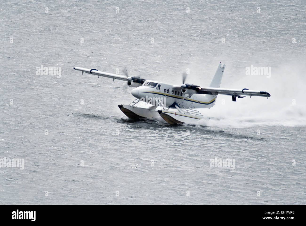 twin propeller engine hydroplan taking off from water surface Stock Photo