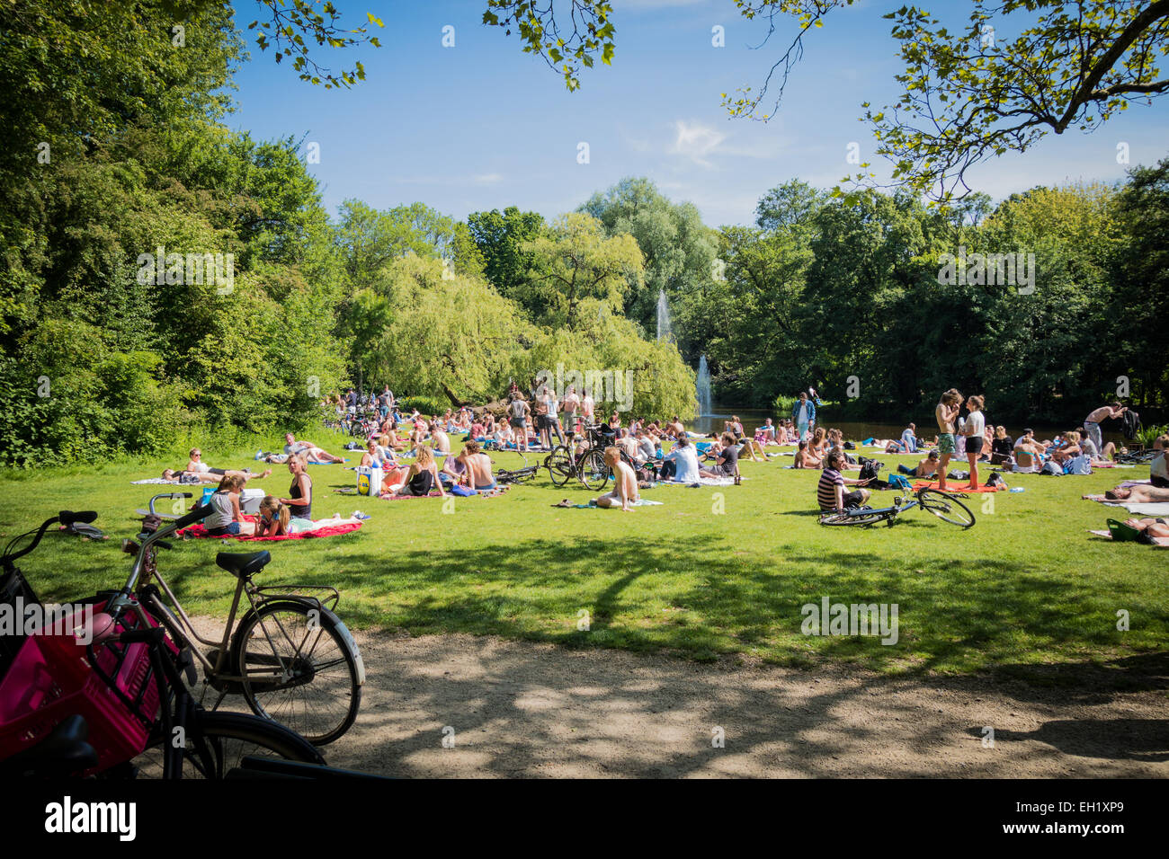 Crowds of people enjoying the sun in Vondelpark amsterdam Stock Photo