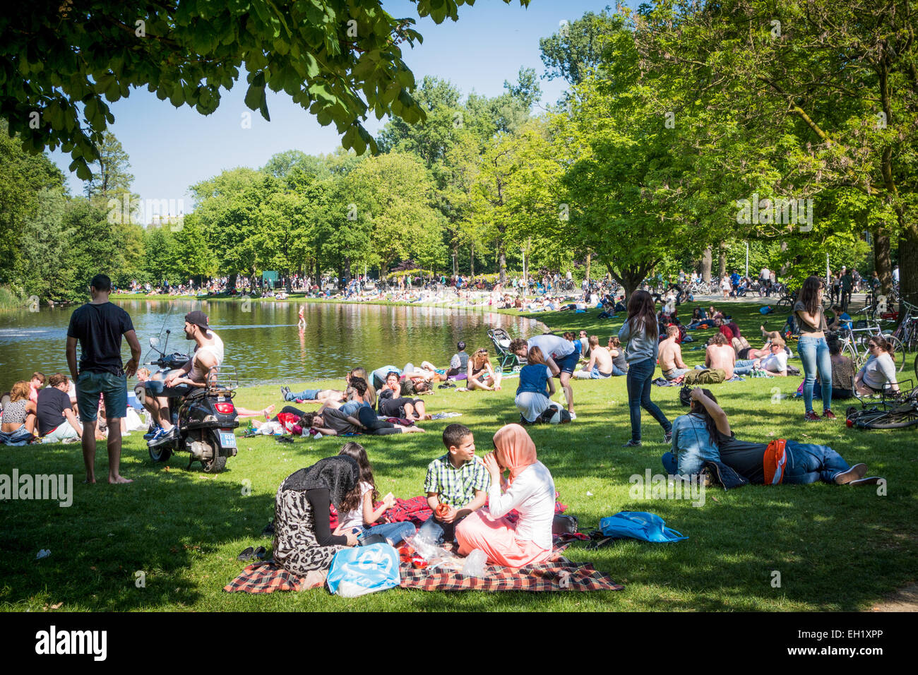 Crowds of people enjoying the sun in Vondelpark amsterdam Stock Photo