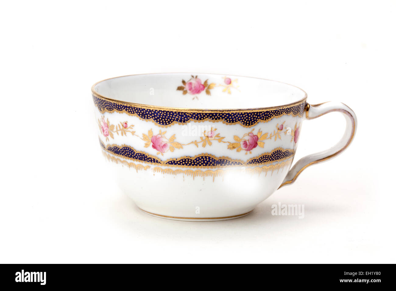Old Wedgwood fine china tea cup decorated in gold, blue & pink roses Stock Photo
