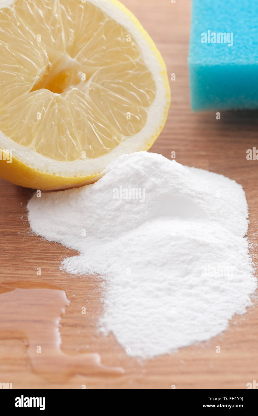 Baking soda, lemon and a sponge. Environmentally friendly cleaning ingredients. Stock Photo