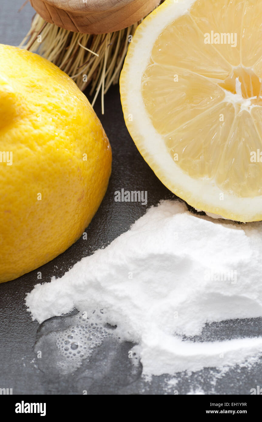 Baking soda, lemon and a brush. Environmentally friendly cleaning ingredients. Stock Photo
