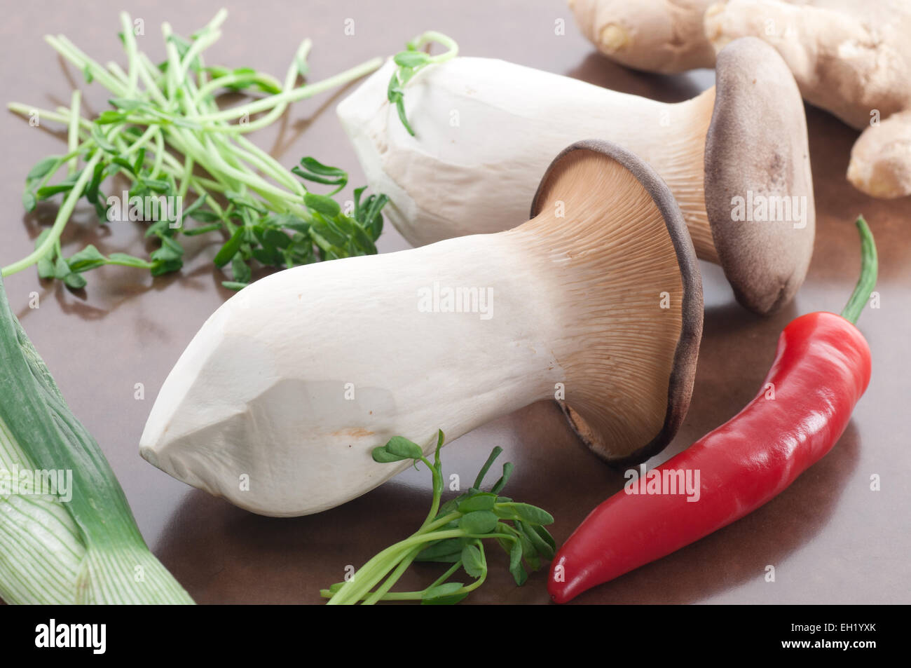 King oyster mushrooms, red chili, pea shoots, leek and fresh ginger. Stock Photo