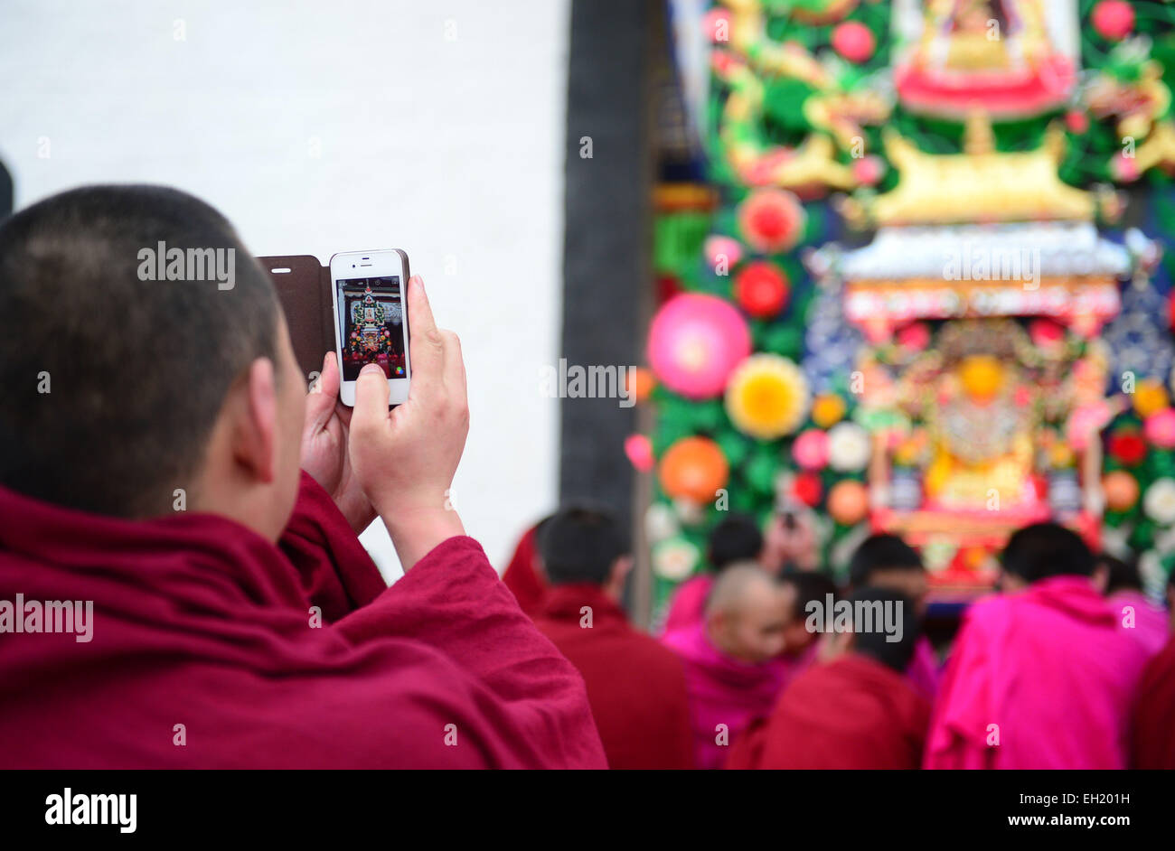 Xiahe, China's Gansu Province. 5th Mar, 2015. A monk take pictures of ghee flower artworks at Labrang Monastery in Xiahe, northwest China's Gansu Province, March 5, 2015. Ghee flower exhibitions are held in Taer Monastery in Qinghai Province and Labrang Monastery in Gansu Province, both presitigious Tibetan Buddhist monasteries, to celebrate the Lantern Festival on March 5. Credit:  Fan Peikun/Xinhua/Alamy Live News Stock Photo