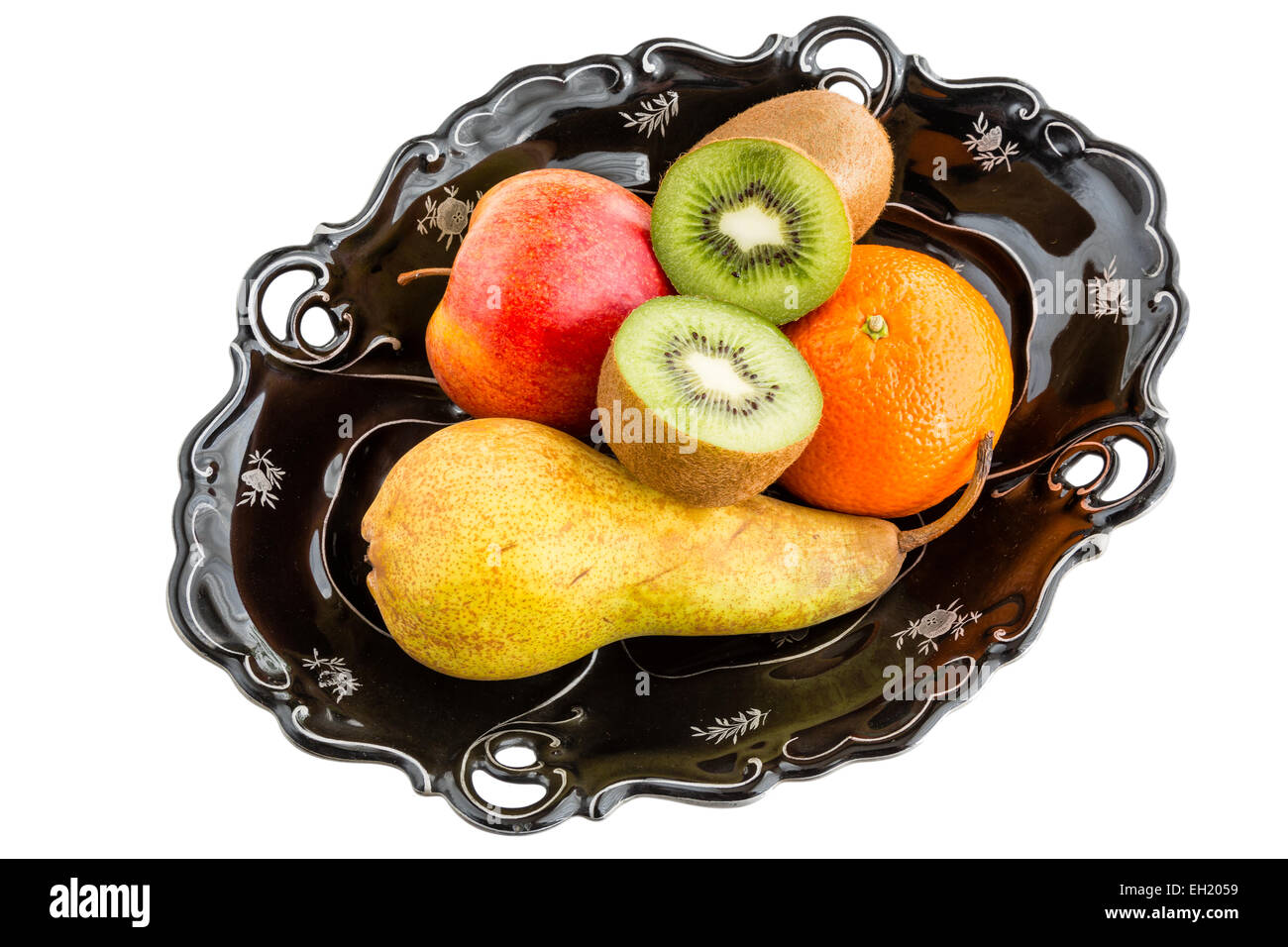 Fruits in vintage bowl - pear, apple, kiwi, mandarin Stock Photo