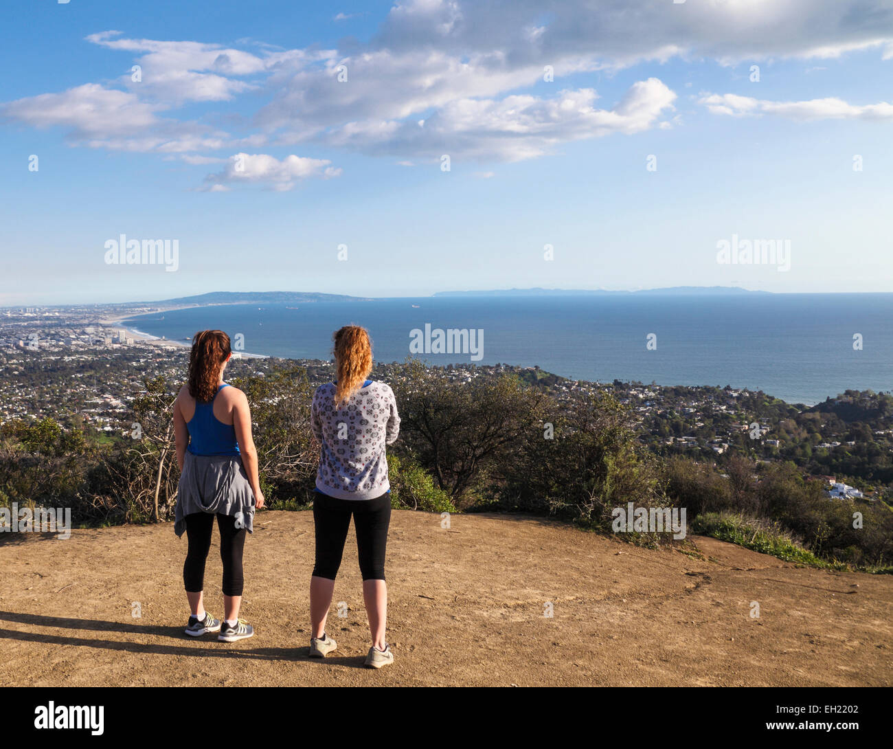 Hikers on the Temescal Ridge Trail in Temescal Canyon Gateway Park, which traverses Topanga State Park,  admire ocean view Stock Photo