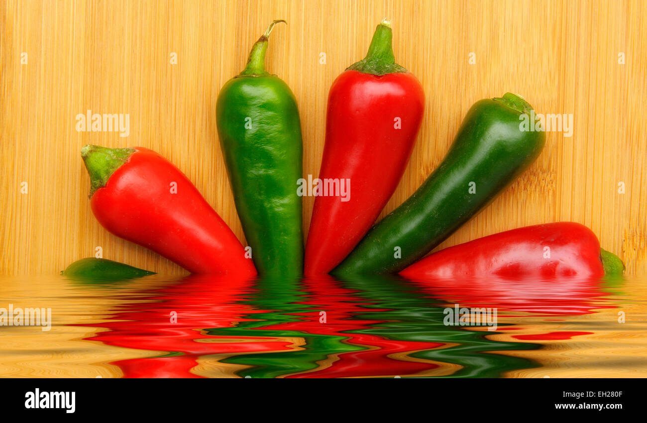 Mixed chili peppers in a digitally created pool of water Stock Photo