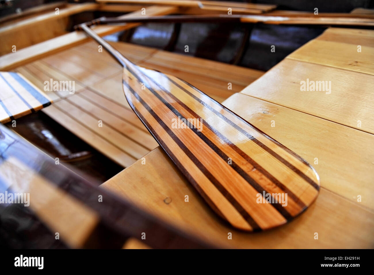 Detail shot with a new wooden paddle in a canoe Stock Photo