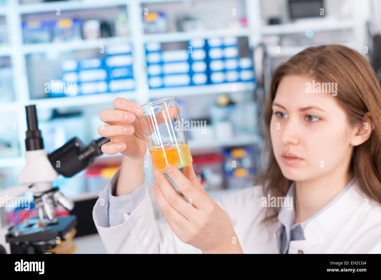 girl in the laboratory testing of food quality egg. Check the content