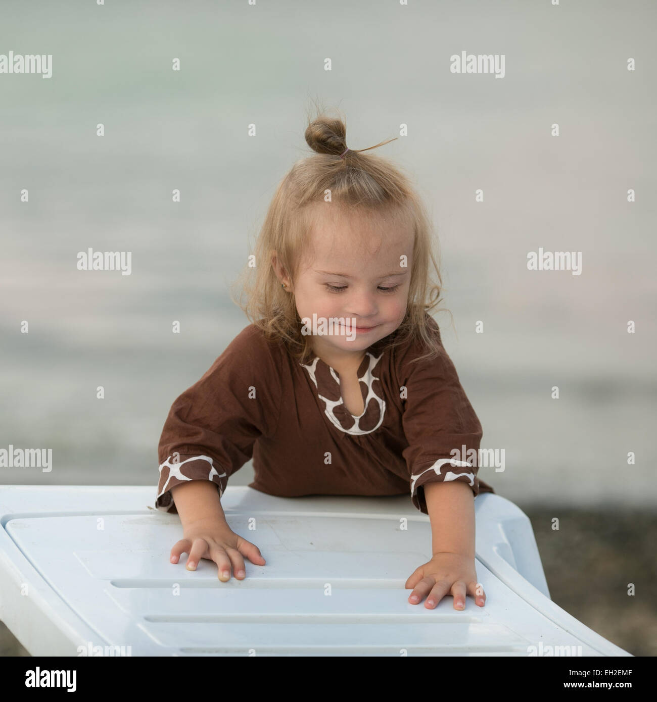 beautiful girl with Down syndrome on the beach Stock Photo