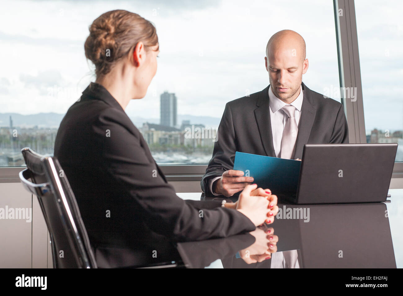 Businessman evaluating the performance of a worker Stock Photo