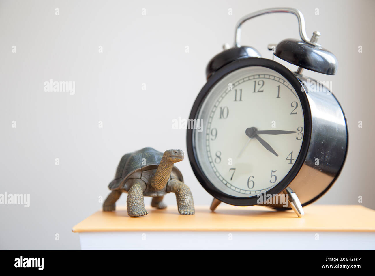 Alarm clock on the book Stock Photo Alamy