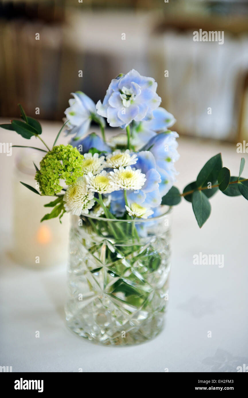 Jam jar with country flowers at a wedding. Stock Photo