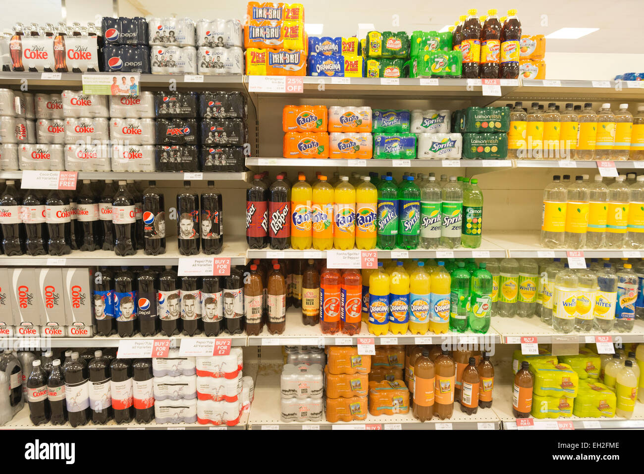 Variety of soft drinks on supermarket shelves Stock Photo
