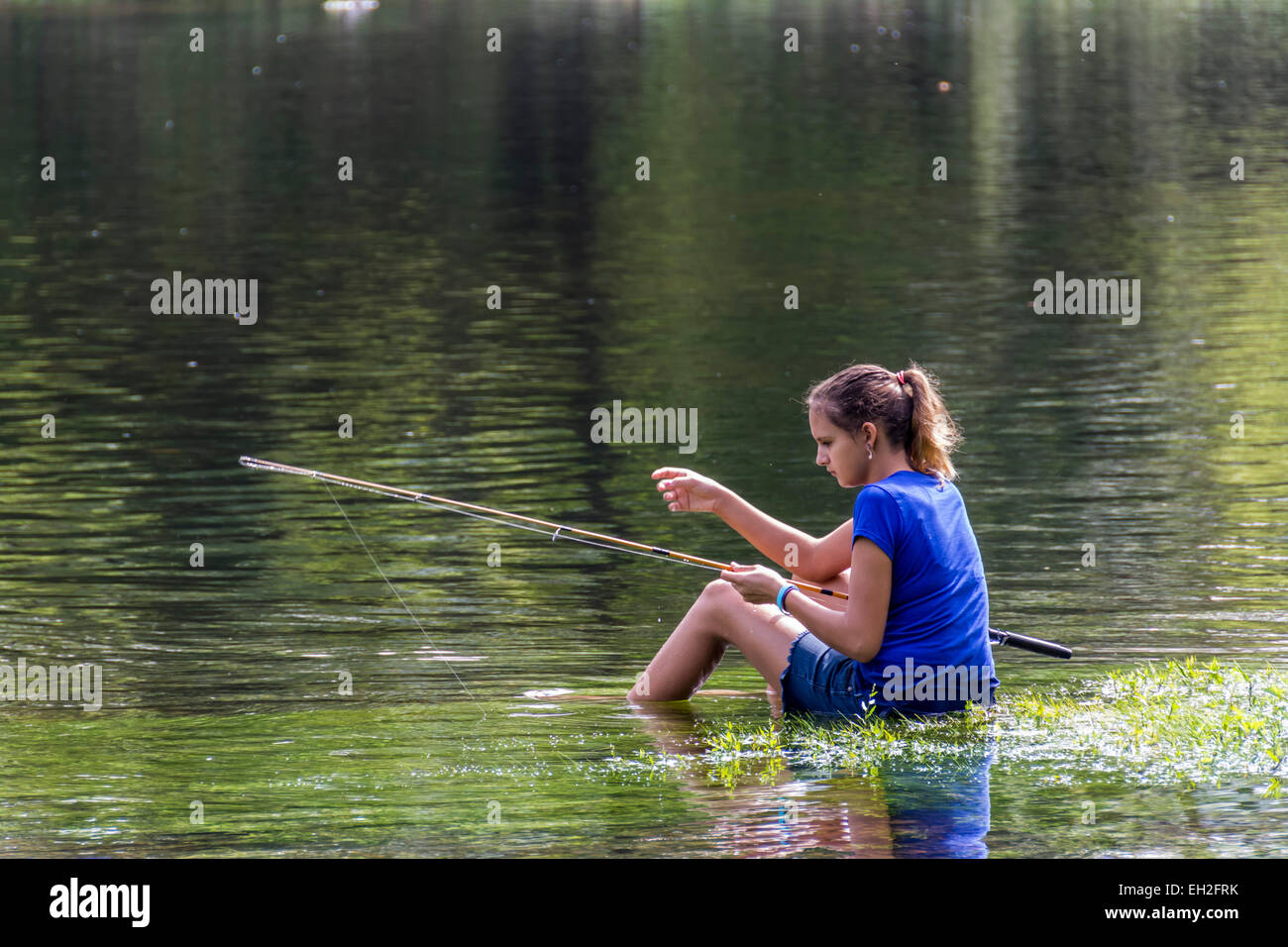 Young girl trout fishing in the Caney Fork River in central Tennessee