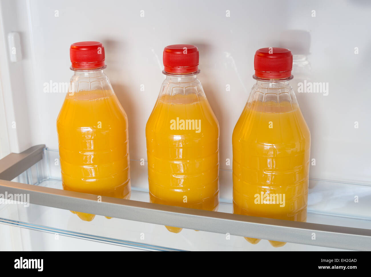 Open fridge filled with orange juice Stock Photo Alamy